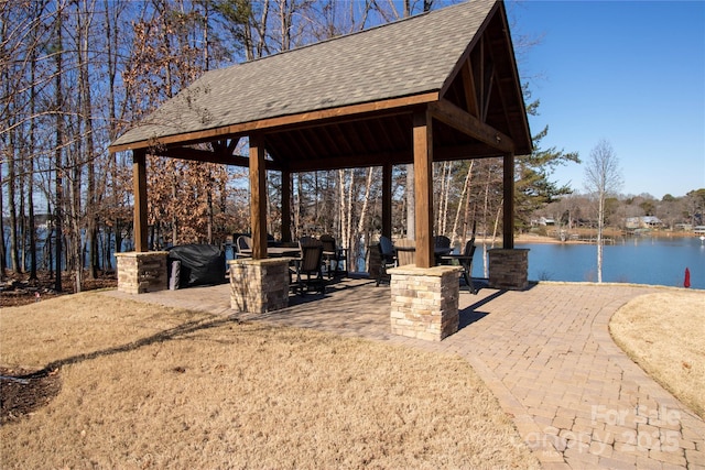 exterior space with a gazebo and a water view