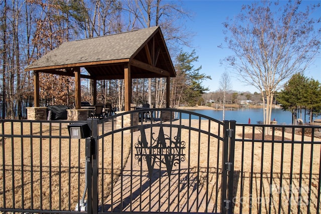 view of gate featuring a gazebo and a water view