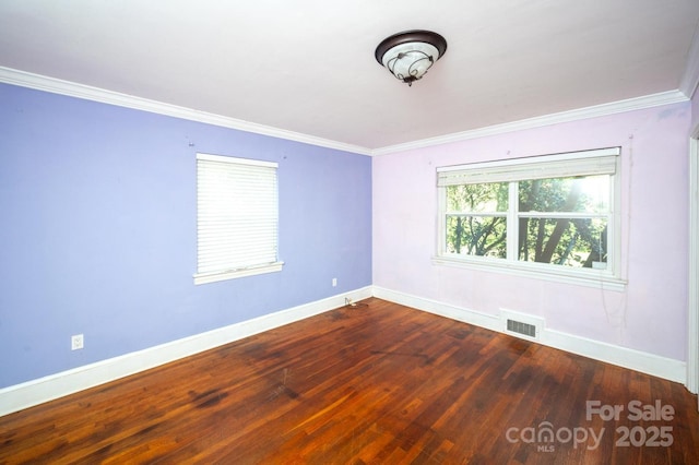 empty room featuring crown molding and hardwood / wood-style floors