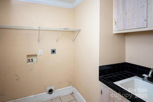 washroom with sink, washer hookup, hookup for an electric dryer, light tile patterned flooring, and ornamental molding