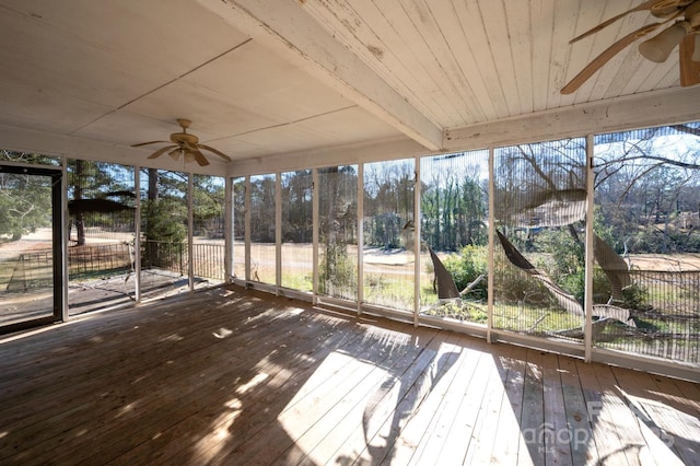 unfurnished sunroom with ceiling fan, beam ceiling, and wood ceiling