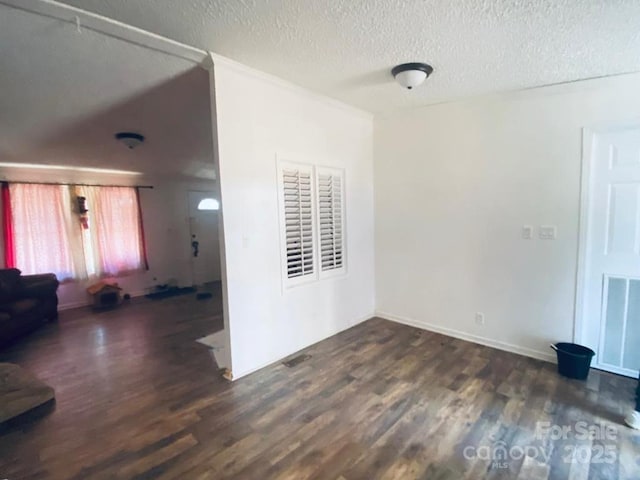 interior space featuring dark hardwood / wood-style floors and a textured ceiling