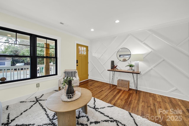 entryway featuring ornamental molding and hardwood / wood-style floors