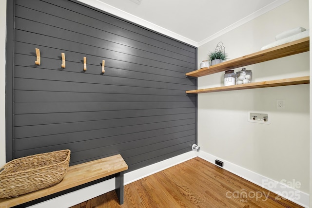 laundry area featuring crown molding, washer hookup, and hardwood / wood-style flooring