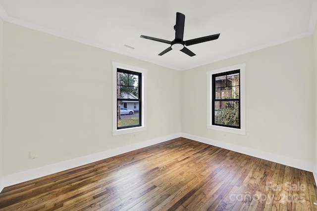 spare room featuring crown molding, ceiling fan, and dark hardwood / wood-style flooring