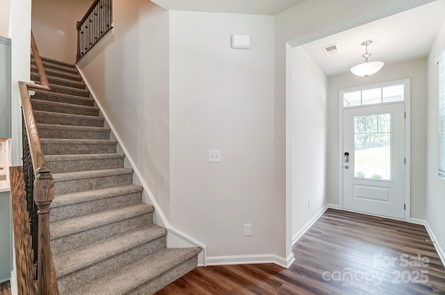 foyer entrance with dark hardwood / wood-style flooring