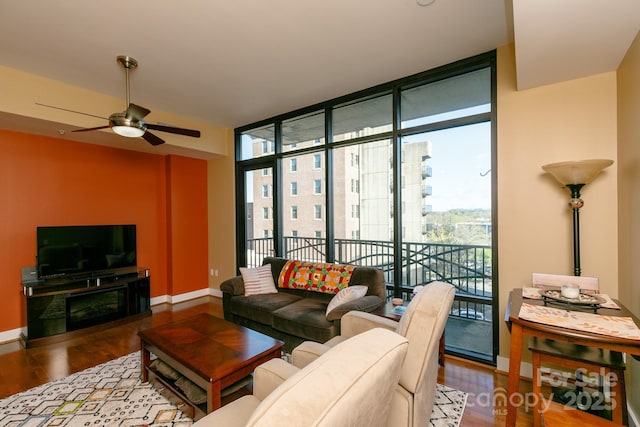 living room featuring floor to ceiling windows, ceiling fan, and hardwood / wood-style flooring