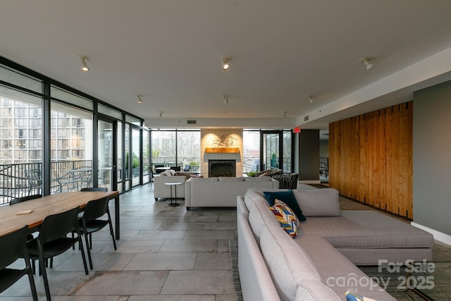 living room with a tile fireplace and expansive windows