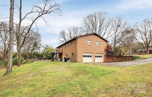 view of home's exterior with a yard and a garage