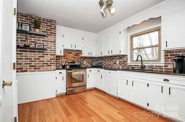 kitchen featuring white cabinetry, dishwasher, sink, stainless steel electric stove, and light wood-type flooring