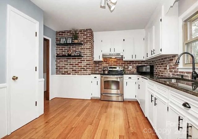 kitchen with white cabinets, stainless steel range with electric stovetop, and sink