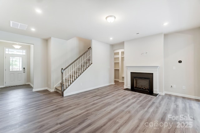 unfurnished living room with light hardwood / wood-style floors