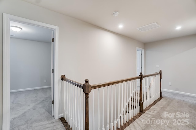 corridor with light colored carpet