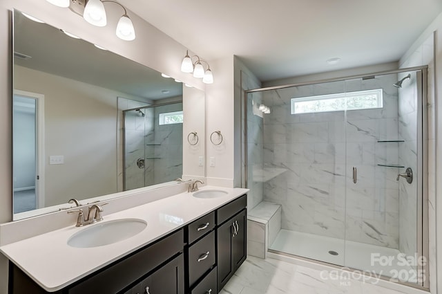 bathroom featuring vanity, walk in shower, and a healthy amount of sunlight