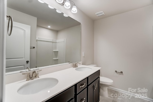 bathroom featuring tile patterned floors, vanity, and toilet