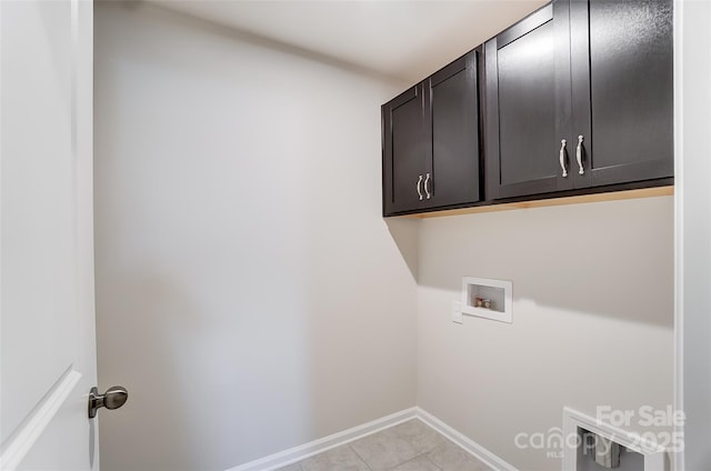 washroom with cabinets, hookup for a washing machine, and light tile patterned flooring