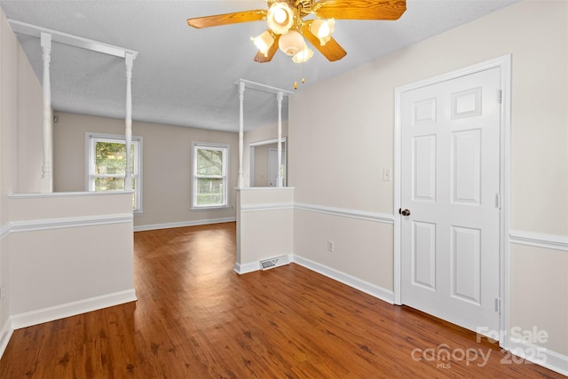 spare room featuring ceiling fan, a textured ceiling, and hardwood / wood-style floors