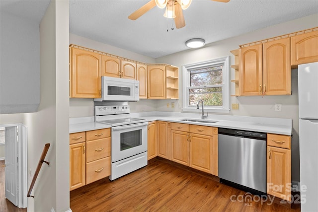 kitchen with white appliances, sink, ceiling fan, dark hardwood / wood-style flooring, and light brown cabinetry