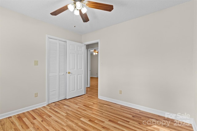 unfurnished bedroom with light hardwood / wood-style floors, a closet, ceiling fan, and a textured ceiling