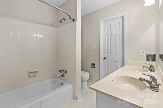 full bathroom with toilet, vanity, tile patterned flooring, and shower / washtub combination