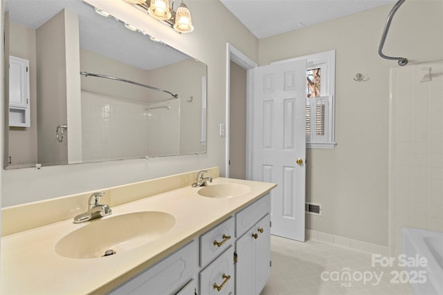 bathroom with tile patterned floors, shower / washtub combination, and vanity