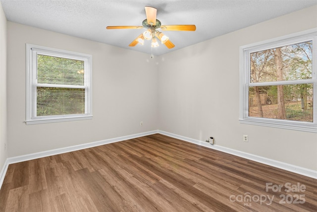 unfurnished room with a textured ceiling, ceiling fan, hardwood / wood-style floors, and a healthy amount of sunlight