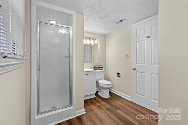 bathroom featuring hardwood / wood-style flooring, a textured ceiling, vanity, and walk in shower