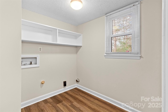 laundry area featuring a textured ceiling, hardwood / wood-style flooring, hookup for a gas dryer, and hookup for a washing machine