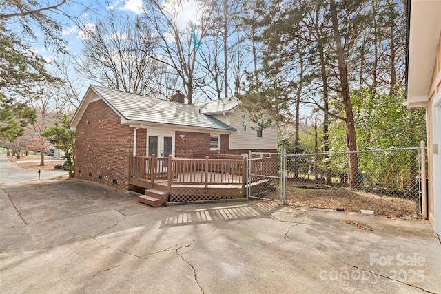 view of front facade with french doors and a wooden deck