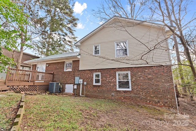 rear view of house with a deck and central air condition unit