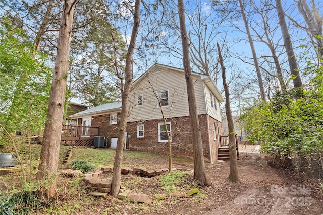 exterior space with a deck and cooling unit