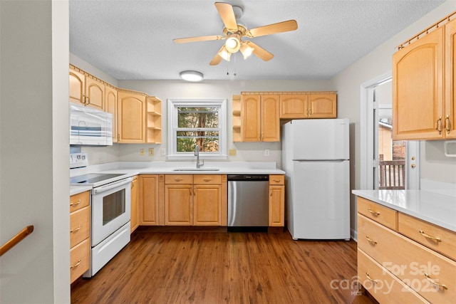 kitchen with sink, white appliances, and light brown cabinets