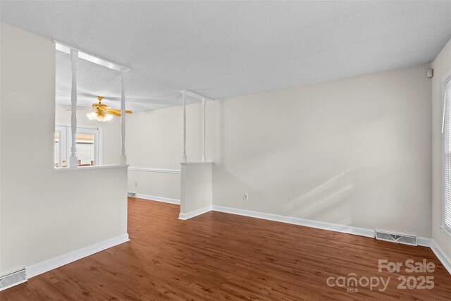 spare room featuring hardwood / wood-style floors, ceiling fan, and a textured ceiling