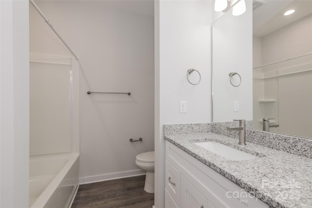 bathroom featuring toilet, wood-type flooring, and vanity