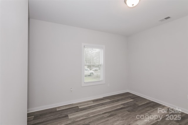 unfurnished room featuring dark wood-type flooring