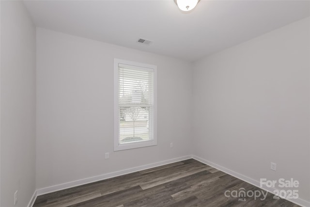 spare room featuring dark hardwood / wood-style flooring