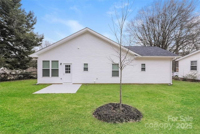 rear view of property featuring a yard and a patio