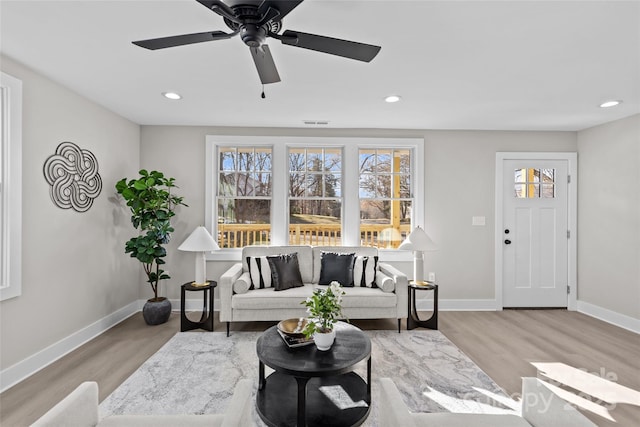 living room with a wealth of natural light and light hardwood / wood-style flooring