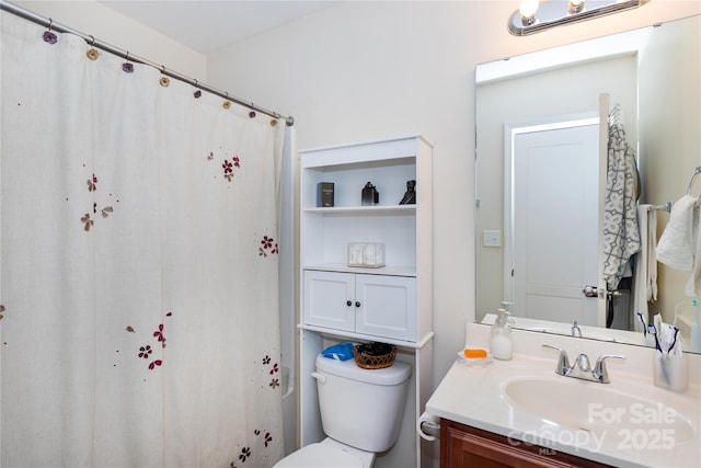 bathroom featuring vanity and toilet