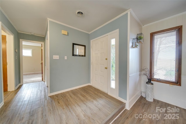 entrance foyer featuring light hardwood / wood-style floors and crown molding