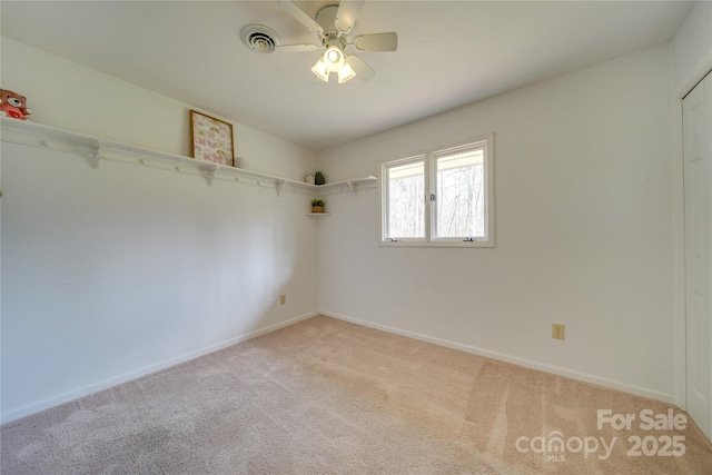 unfurnished room featuring light carpet and ceiling fan