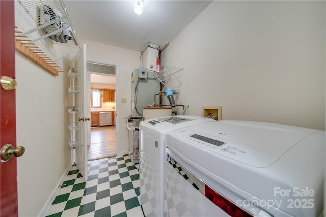 clothes washing area featuring separate washer and dryer