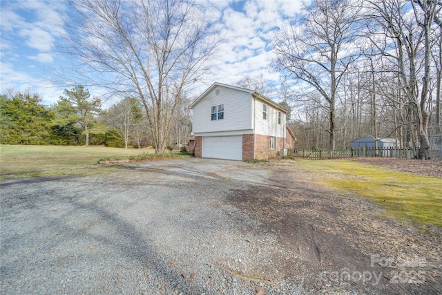 view of home's exterior with a yard and a garage