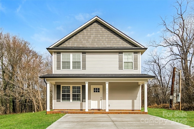 view of property with covered porch and a front yard