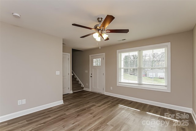 entryway with ceiling fan and dark hardwood / wood-style flooring