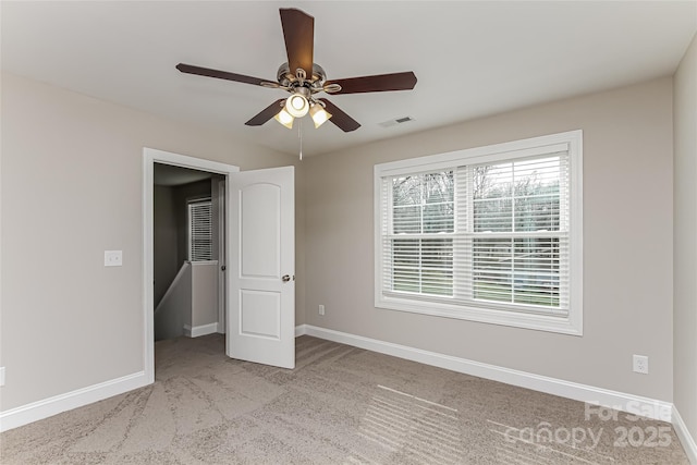 unfurnished bedroom with ceiling fan and light colored carpet