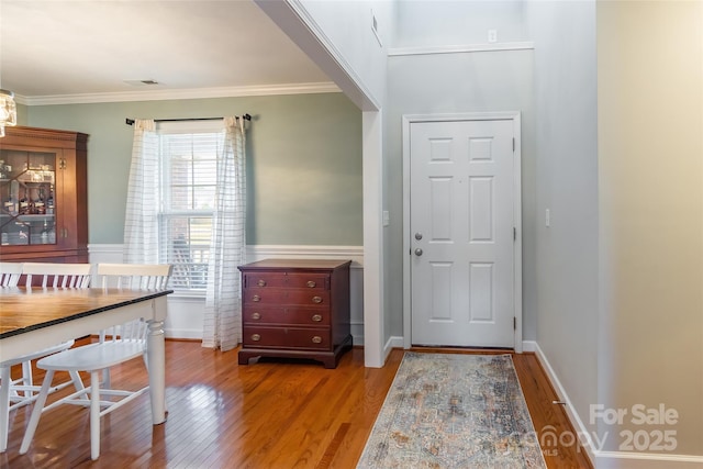 foyer with light hardwood / wood-style floors and ornamental molding