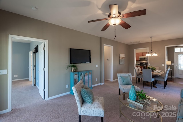 living room with light colored carpet and ceiling fan with notable chandelier