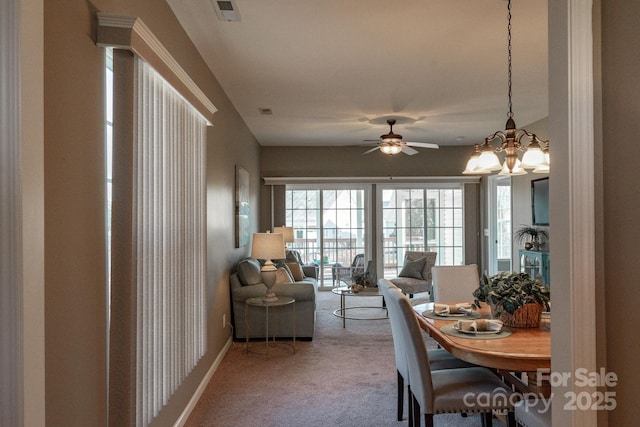 dining area with ceiling fan and carpet floors