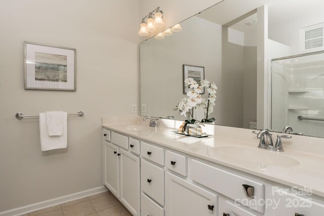 bathroom with tile patterned flooring, toilet, vanity, and walk in shower